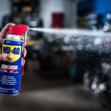 Imagem de uma lata de WD-40 sendo usada para lubrificar e proteger componentes metálicos de ferramentas e maquinários.