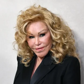 Jocelyn Wildenstein, conhecida como Mulher-Gato, posa em um evento com seu rosto transformado por cirurgias plásticas e um vestido extravagante, em meio a um cenário de glamour